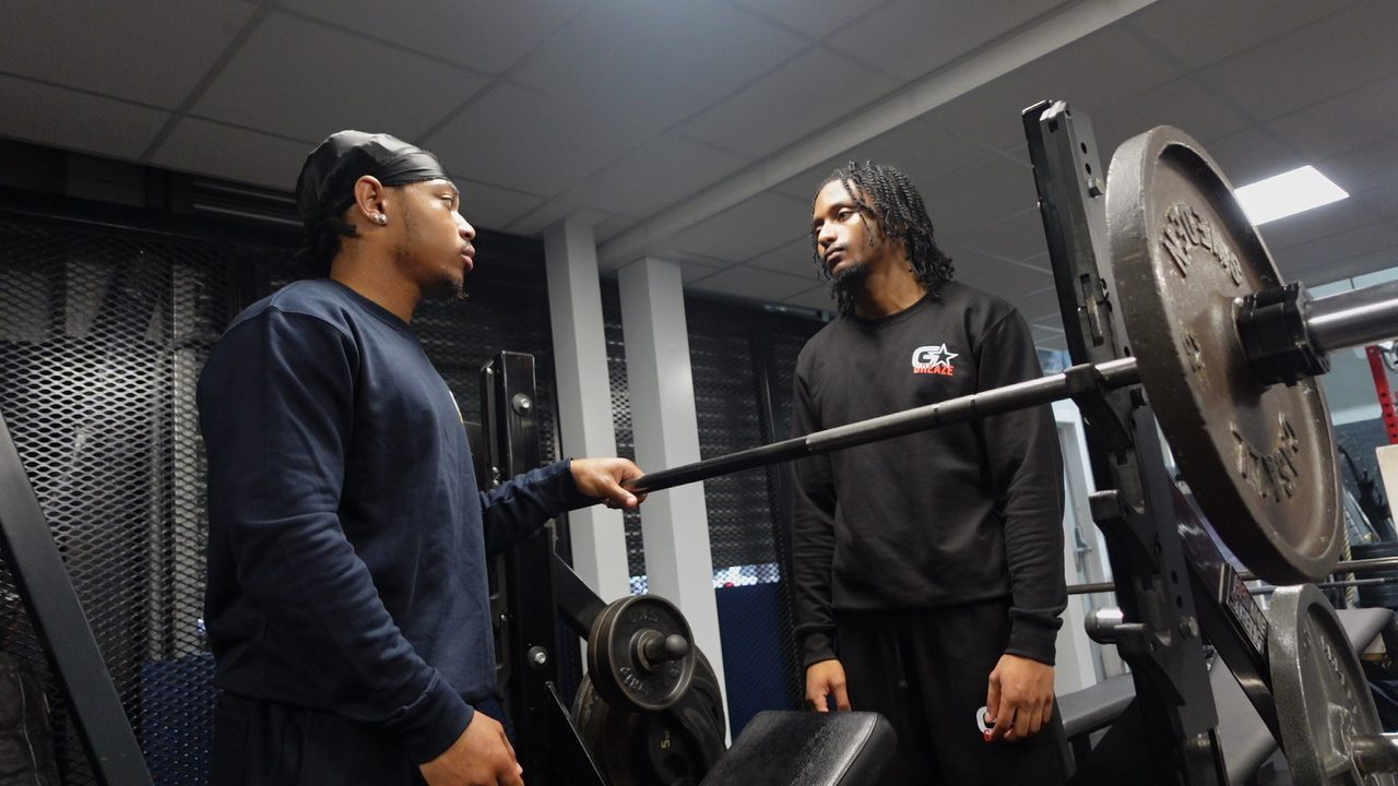 Partners training with barbell